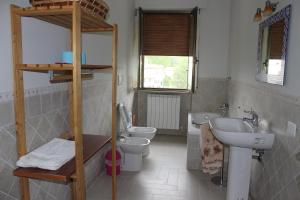 a bathroom with two toilets and a sink at L'Ortolano Apartments in Spoleto +96 photos