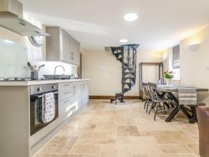 a kitchen and dining room with a table and chairs at 1 Bed in Moccas 87736 in Moccas +10 photos