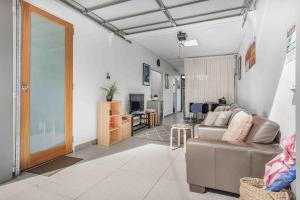 a living room with a couch and a table at FOSS4A - A Private Garage Suite in Forest Lodge in Sydney