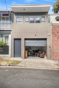 a house with a garage with a couch in it at FOSS4A - A Private Garage Suite in Forest Lodge in Sydney +9 photos