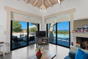 a living room with a tv and a fireplace at Villa Resi in Vamos +55 photos