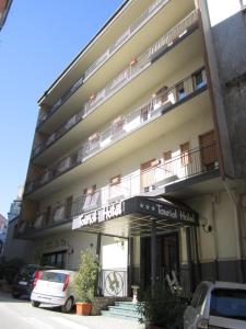 a building with a sign for a hotel at Tourist Hotel in Potenza