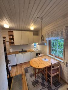 a kitchen with a wooden table in a room at Kutala Cottage in Kutala
