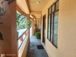 an empty hallway of a building with a window at Rose Mary Guest House in Cherrapunji