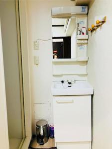 a small kitchen with a sink and a mirror at 冠京ホテル in Tokyo