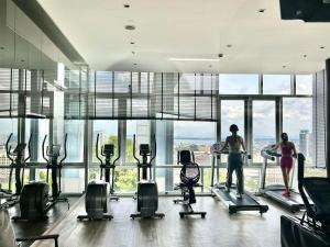 two women exercising in a gym with large windows at Centric Sunset Beach in Pattaya Central