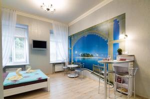 a room with a bedroom with a bed and a table at Alfa Apartments Levytskoho 3 in Lviv