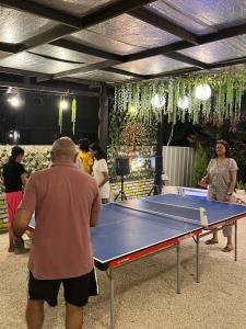 a man standing around a ping pong table at Stay Sukoonn Off Beat Staycation in Mohan Chatti