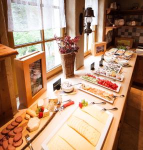 a table with many different types of food on it at Amselgrundschlösschen in Kurort Rathen