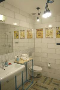 a white bathroom with a sink and a toilet at Dom Pod Skałą in Jeleniów