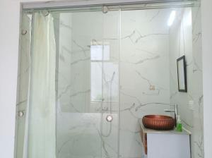 a bathroom with a shower and a sink at Tapovan home by Jabula Getaways in Rishīkesh