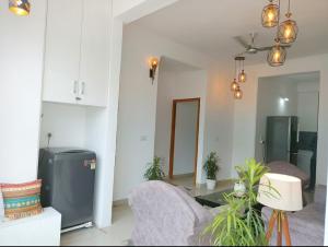 a living room with two chairs and a table in a room at Tapovan home by Jabula Getaways in Rishīkesh +12 photos