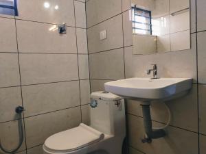 a bathroom with a sink and a toilet at Vilstay Go Hill View Residency in Jāmb