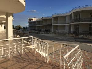 a row of white chairs in front of a building at Town-house Golden Bugaz in Karolino-Buhaz