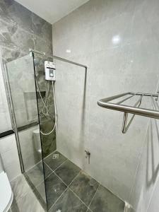 una ducha con puerta de cristal en un baño en Your Red Earth Homestay, en Krabi