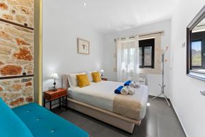 a bedroom with a bed with yellow and blue pillows at Villa Resi in Vamos +40 photos