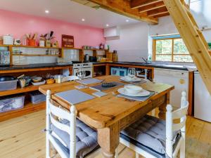 a kitchen with a wooden table in a room at 1 bed in Llandysul 85671 in Rhyd Owen