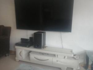 a flat screen tv sitting on top of a cabinet at Peacock palace in Nairobi