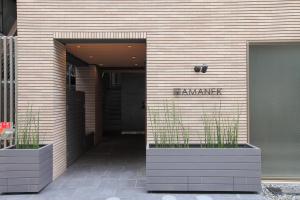 a doorway leading to a building with a blue door at Hotel Amanek Ginza East in Tokyo