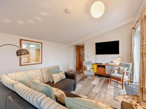 a living room with a couch and a flat screen tv at 1 Bed in High Bickington 55322 in High Bickington