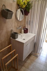 a bathroom with a sink and a mirror at Holiday House Etna Mare Taormina in Mascali