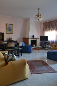 a living room with a couch and a table at Holiday House Etna Mare Taormina in Mascali