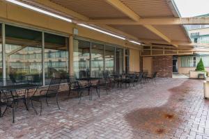 an empty patio with tables and chairs in a building at Quality Inn in Hermitage