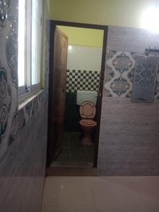 a bathroom with a toilet in a small room at Sri Kanna Lodge CMC Vellore in Vellore
