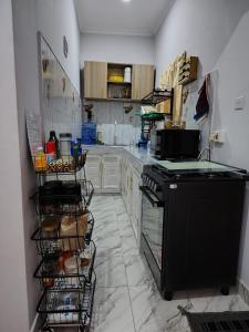 a kitchen with a black stove and cabinets at The Nest Haven in Malindi