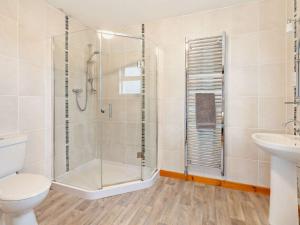 a bathroom with a shower and a toilet and a sink at 2 Bed in Edzell CA300 in Edzell +17 photos