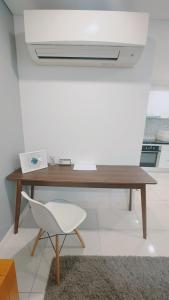 a wooden desk with a white chair in a room at Horizon Condo 1BR in Choeng Mon Beach +12 photos