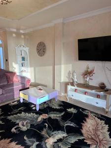 a living room with a couch and a table at Villa Alexander in Puerto de Santiago