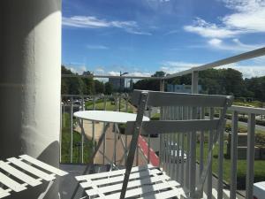 a table and chairs on a balcony with a view at Holidaysuite Mathilda in Ostend