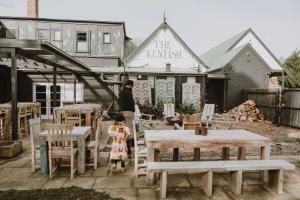 a woman and a little girl standing next to tables and chairs at The Kentish Tasmania in Oatlands