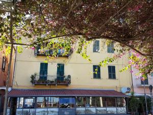 a building with windows and balconies on a street at Perla Nera Guesthouse in Imperia
