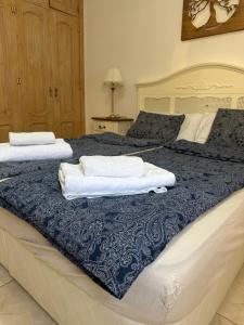two beds with towels sitting on top of them at Villa Alexander in Puerto de Santiago +36 photos