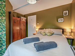 a bedroom with a large bed with two pillows on it at 2 Bed in Woolacombe 77248 in West Down