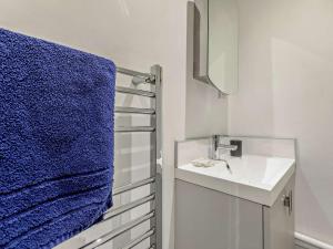 a bathroom with a sink and a blue towel at 2 Bed in Woolacombe 77248 in West Down +12 photos