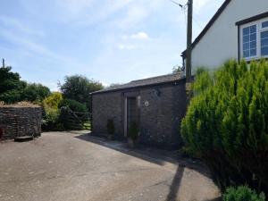 a brick building with a door in a yard at 2 Bed in Woolacombe 77248 in West Down