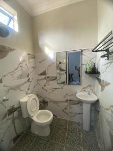 a bathroom with a toilet and a sink at Suria guesthouse in Kampung Raja +7 photos