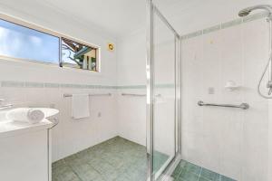 a bathroom with a shower and a sink at Ocean Echoes - Pet Friendly with Ocean Glimpses in Culburra Beach +25 photos