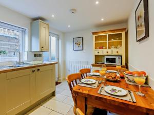 a kitchen with a wooden table with chairs and a dining room at 2 Bed in Ludlow 91422 in Ludlow