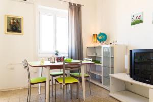a dining room with a table and chairs and a tv at Apartment Mia in Rijeka