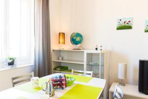 a dining room with a white table and chairs at Apartment Mia in Rijeka