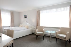 Letto o letti in una camera di Frühstückshotel Seemannsbraut Amrum-adults only ab 18 Jahre-keine Haustiere-