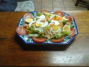 a plate of food with eggs and tomatoes on a table at Casa Rural Landa in Galbarra