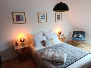 a bedroom with a bed with shoes on it at Chambre avec jacuzzi extérieur in Strasbourg