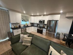 a living room with a green couch in a kitchen at Townhouse in Prime Location! in McCall