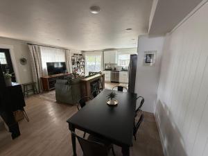 a living room with a table and a kitchen at Townhouse in Prime Location! in McCall
