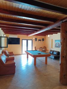a living room with a ping pong table in it at Casa Claudia in Slănic-Moldova